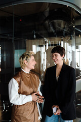 Two businesswoman discussing project during meeting in office