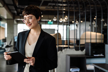 Young woman manager working on tablet in modern office space