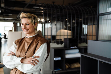 Positive creative business woman standing in office