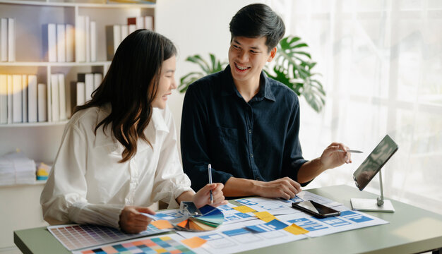 Asian businessman and woman people meeting in office. Employee brainstorm and work as team, plan and discuss project by point on paper and tablet.
