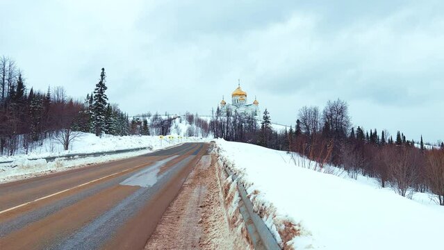 Belogorsky St. Nicholas Orthodox Missionary Monastery. Russia, Perm Krai, Belaya Gora. The temple on the hill in winter. Monastery on the background of snow. 4K