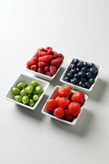 Concept of fresh food, berries on light background