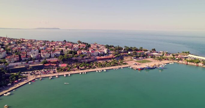 aerial view of the sea and the coast. Aerial view of Gerze harbor on a sunny summer day. Lighthouses and small harbors. Black Sea coast. Aerial shot of a small seaside town.
