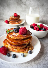 Pancakes with berries. breakfast. On a concrete background
