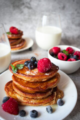 Pancakes with berries. breakfast. On a concrete background