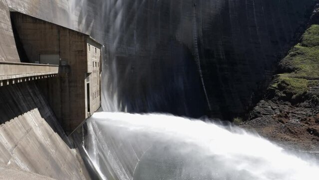 Water released in large stream from arch wall of Katse Dam in Lesotho