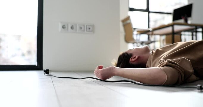 Woman received electric shock when disconnected from mains and lies on floor