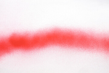 red line of spray paint on white paper