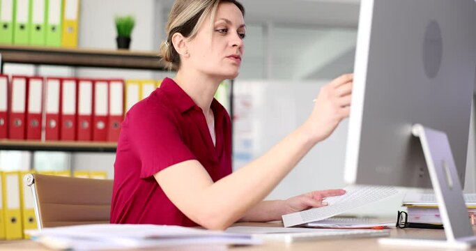 Serious attentively business woman working with documents and computer in fose