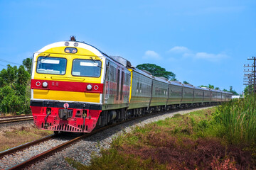 Fototapeta na wymiar Passenger train by diesel locomotive passed the railway curve.