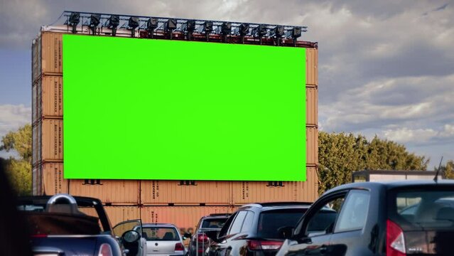 Drive In Cinema Green Screen Theater Exterior Cars Parked. green screen in a drive in theater with cars parked watching movie