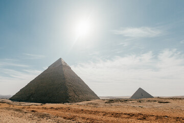 Fototapeta na wymiar Sun over pyramids in Giza, Egypt