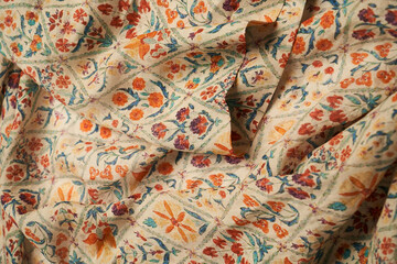 Orange cotton textile background. Folded linen fabric