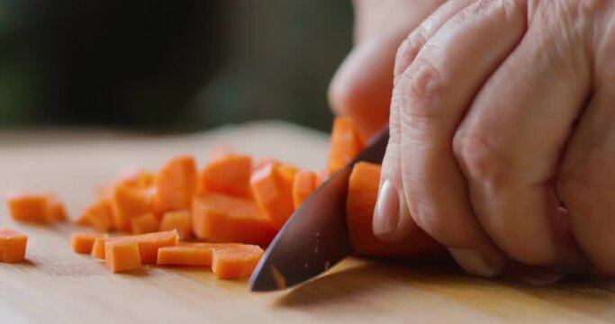 chopping carrots, chopping carrots for food on cutting board