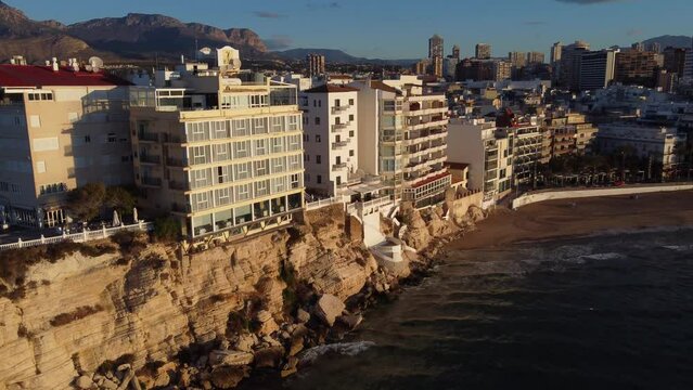 Waterfront properties along the cliffs of the popular tourist town of Benidorm, Spain - aerial