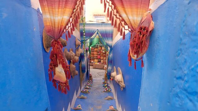 Secluded ornate alleyways within the magical city of Chefchaouen, The Blue Pearl, Morocco. Tilt up shot