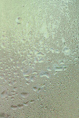 Water drops on a window, textured background, pastel colors, defocused