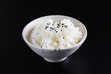 Japanese rice on cup isolated in black background
