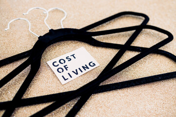 shopping and purchasing power, group of clothes hangers with Cost of Living text in the middle...