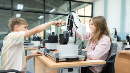 Children using the hand robot technology and having fun Learning, Students are studying technology, which is one of the STEM courses.