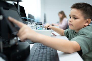 Youngsters utilizing the hand robot technology are having fun learning the electronic circuit board and hand robot controller of robot technology, which is one of the STEM courses.