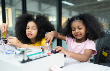 Children using the hand robot technology and having fun Learning the electronic circuit board of hand robot technology, which is one of the STEM courses.