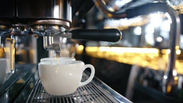 priofessional coffee machine pours coffee into a cup in a restaurant. slow motion . High quality 4k footage