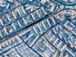 drone view of city streets covered by snow from above