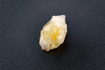 Crystal of Citrine yellow quartz mineral gem stone. Black background