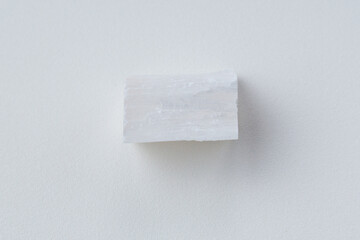 White selenite, variety of the mineral gypsum, zen meditation stones, white background