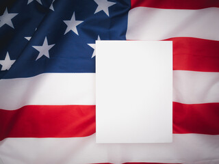 A blank white paper over the American flag background