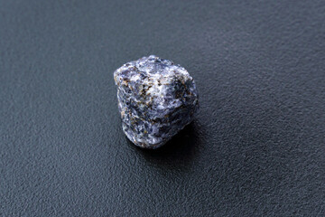 Crystal of cordierite iolite gem stone cutout, raw mineral, black background