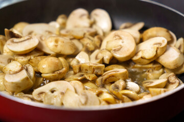 Mushroom champignon soup is cooked. Mushrooms are boiling close-up.