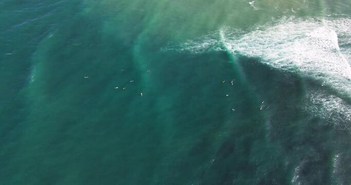 Aerial View of Parlamentia Surf Break French Basque Country with swell lines and surfers catching waves from the line-up and riding them to shore