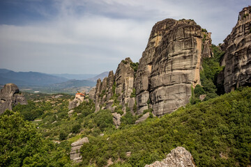 Fototapeta na wymiar Amazing and beautiful Orthodox Christiaan monasteries built on huge cliffs at Meteora, Greece, cloudy moody day colorful travel perspective 