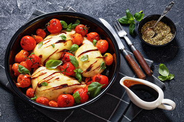 caprese chicken in black baking dish, top view