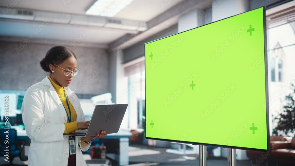 Poster portrait of young black woman working in a lab of industrial startup. female specialist using a lapt