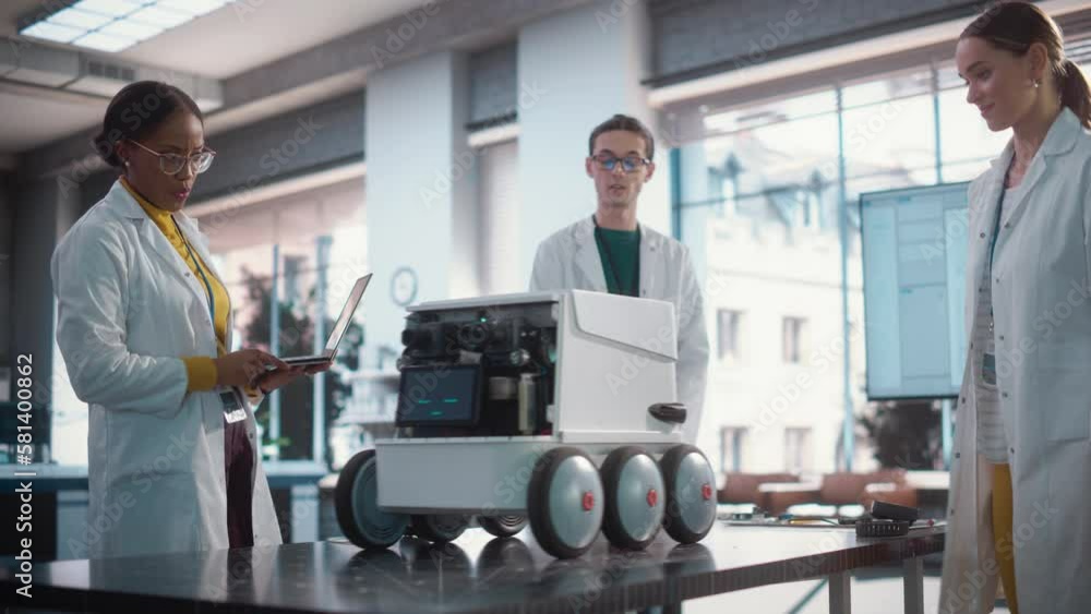 Aufkleber Diverse Team of Industrial Specialists Working on Remotely Controlled Robot, Using a Laptop. Young Male and Female Engineers Discussing an Autonomous AI Delivery Assistant Prototype, Brainstorming