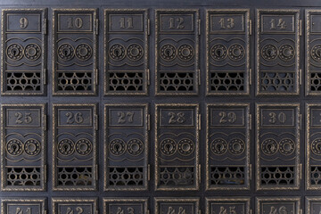 Old retro copper mailboxes with numbers. Lot mail cells in the post office. Antique letter box