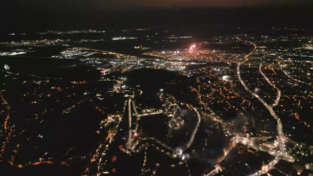drone footage of fireworks in the night over city view