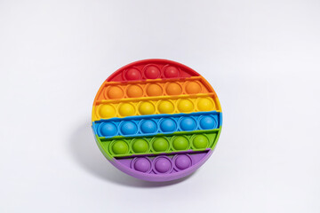 Multi-colored anti-stress toy. Simple Dimple in rainbow colors on white background
