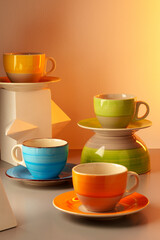 Colorful clay ceramic cups on gray background