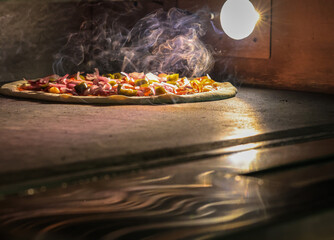 Fresh Pizza going into the oven and beginning to cook with bottoms free space