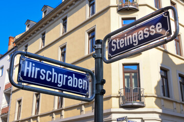  Sign post at the intersection of a dead end road and a one way road with a old European building in the background. Taken in Wiesbaden Germany