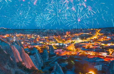 Goreme village in Cappadocia at twilight blue hour with fireworks - Goreme, Turkey 