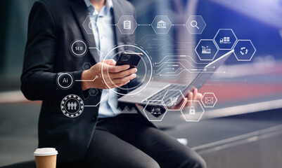 Digital marketing media in virtual screen.businessman hand working with mobile phone and modern compute with VR icon diagram at office in morning light