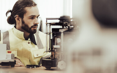 Computer science development engineer working on robotic arm connection and control at electronic futuristic technology center. Modern people training in industry 4.0 automated engineering workshop