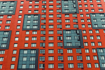 multi-storey house of red color, photo in the afternoon