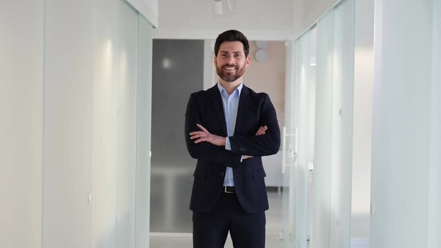 Ideal portrait of business man in a suit in office lobby exudes professionalism, confidence. Communication, leadership, decision making skills are other critical attributes that define his success.