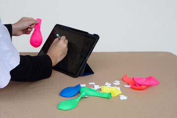 Closeup student writes on smart tablet during studying about static electricity lesson from...